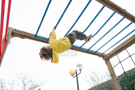 Child playing in a playground structure