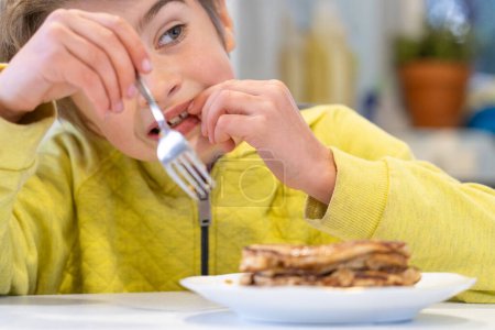 Closeup of a child eating homemade pancakes