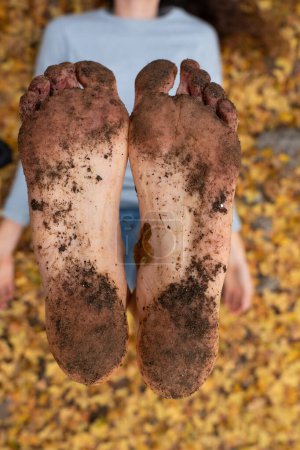 Photo for Bare feet of woman with dirt from walking barefoot seen close up - Royalty Free Image
