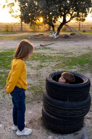 Children playing with tire wheels