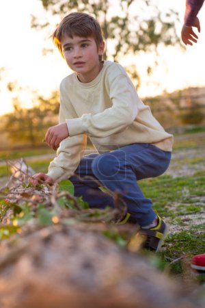 Boy playing in nature at sunset