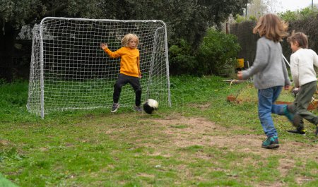 Children friends playing soccer outdoors