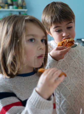 Photo for Two children eating homemade pizza together - Royalty Free Image