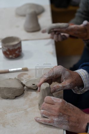 Hands working pottery in a pottery workshop