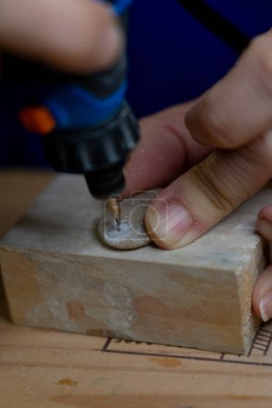 Rotary tool carving a stone