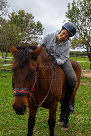 Junge Frau reitet Pferd in der Natur