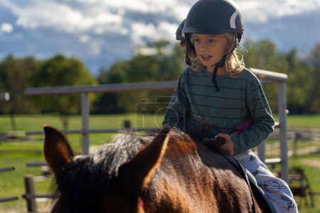 Photo for Boy riding a horse in a horse therapy center - Royalty Free Image