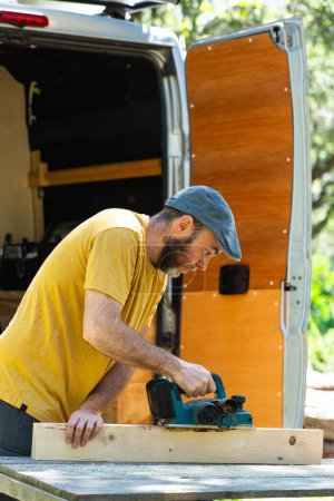 Man working to camperize his camper van