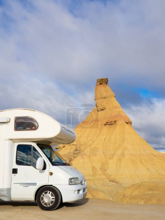 Vertical photo of a motorhome in a desert. Adventure traveling