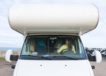 Woman putting the gps to start driving a motorhome trip
