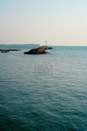 Photo for Looks far away from a wide angle from the lighthouse at the breakwater in the middle of the sea. - Royalty Free Image