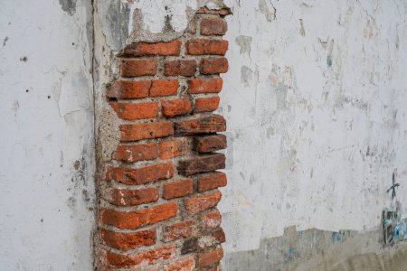 Photo for Looks close to the wall which has been removed until the red brick is visible - Royalty Free Image