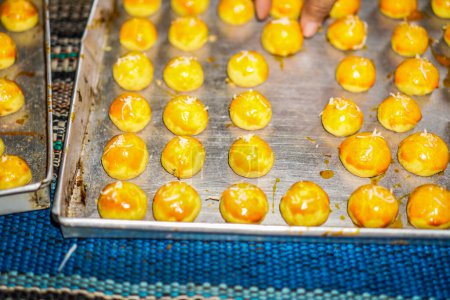 Close-up view of pineapple cakes arranged neatly in a baking pan.