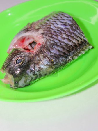Grilled tilapia is being smeared with oil