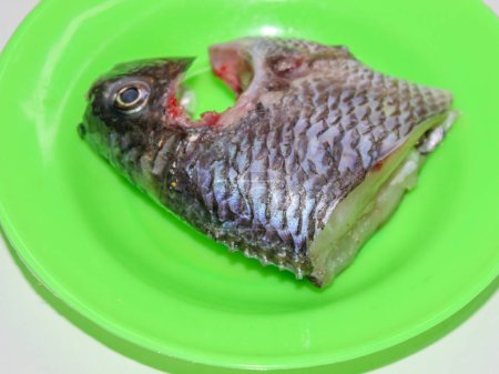 Grilled tilapia is being smeared with oil