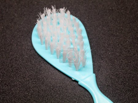 White hair brush with light blue handle