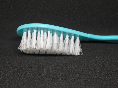 White hair brush with light blue handle