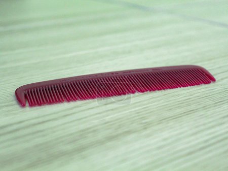 Small red comb on the table