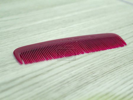 Small red comb on the table
