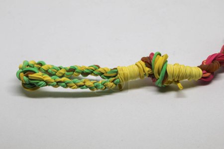 Rubber bands woven into a blowpipe, isolated white