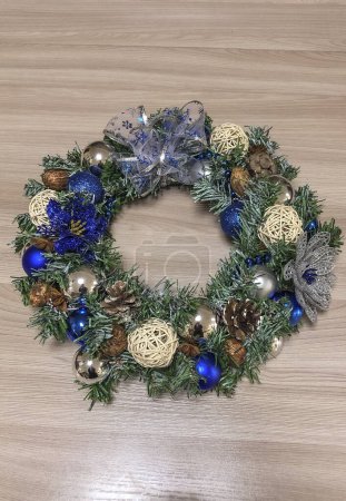 Photo for Christmas wreath with blue and silver decorations on the wooden floor. - Royalty Free Image