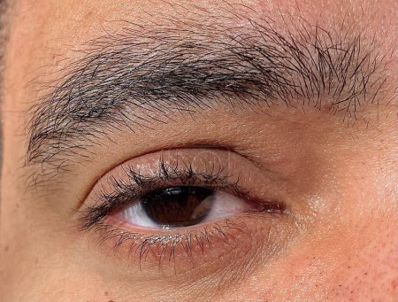 Brown eye of a man in close-up