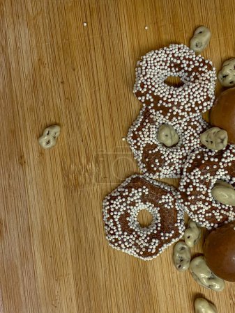 Homemade gingerbread cookies in chocolate on a wooden background. View from above.