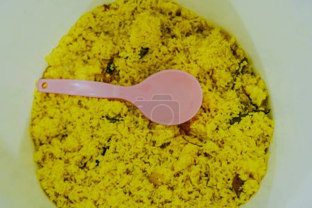 Nasi kuning or yellow rice in thermos.Yellow rice is a typical Indonesian food made from rice cooked with turmeric, coconut milk and spices.Yellow rice is served in Indonesian cultural celebrations.