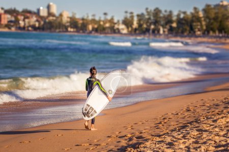 Photo for SYDNEY, AUSTRALIA - CIRCA AUGUST 2016: man going surfing at the Manly Beach, Manly, Northern Sydney, New South Wales, Australia - Royalty Free Image