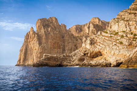 Photo for Granite cliffs in front of Bombarda Cave, Marettimo, Egadi Islands, Italy - Royalty Free Image