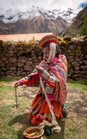 Photo for Woman in traditional clothes hand-spinning wool, Huilloc, Sacred Valley, Cusco, Peru - Royalty Free Image