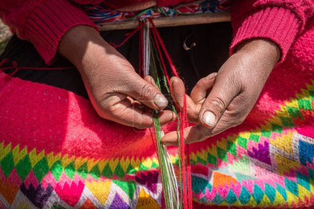 Hands of an Andean woman plying wool, Sacred Valley, Cusco, Peru