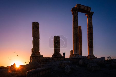 Photo for Silhouette of flying kites at the Temple of Hercules against clear sunset, Amman Citadel, Amman, Jordan - Royalty Free Image