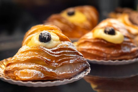 Photo for The famous sfogliatellla riccia (also called lobster tail in the US), a traditional shell-shaped, filled pastries from Naples, Italy. - Royalty Free Image