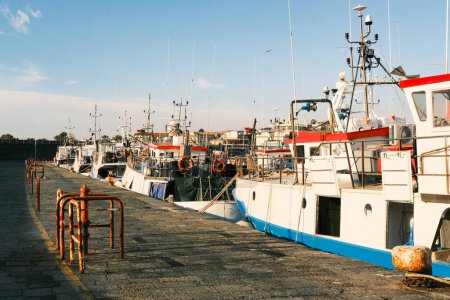 Photo for Fishing boats lined along the quay of the fishing harbor of Riposto, Catania, Italy - Royalty Free Image