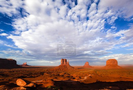 Photo for Famous view of Monument Valley with Mittens and Merrick buttes at sunset. Saddleback meta, Stagecoach and Castel Rock on the left. - Royalty Free Image