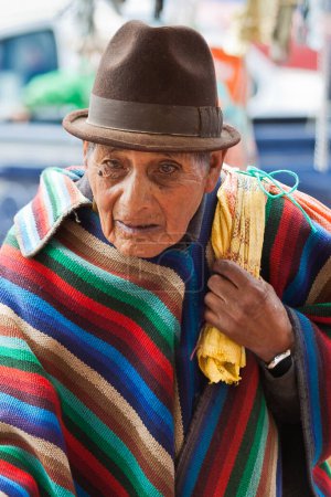 Photo for An elderly man in traditional Andean poncho and hat, Saquisili market, Ecuador - Royalty Free Image