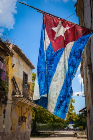 Téléchargez les photos : Grungy drapeau cubain agitant dans une rue de la Vieille Havane avec des bâtiments en décomposition, La Havane, Cuba - en image libre de droit