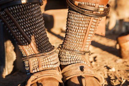 Omohanga, traditional Himba anklets made of metal beads that adult women wear to adorn their feet, carry small items, and protect against venomous animals. Katutura, Windhoek, Namibia.
