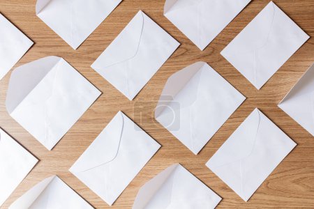 Photo for Group of white envelopes flat lay on a wooden table - Royalty Free Image