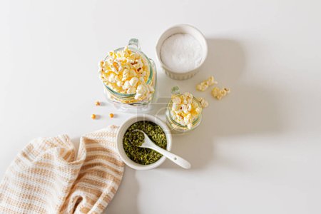 Photo for Top view of aesthetic beige composition with popcorn in kitchenware. Autumn, winter food concept. - Royalty Free Image