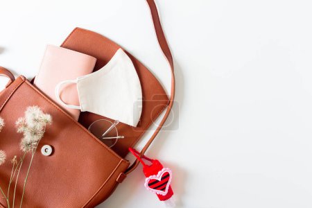 Photo for Female fashion beige styled composition. Purse, mask, glasses, wallet on white background with copy space. Flat lay, top view. - Royalty Free Image