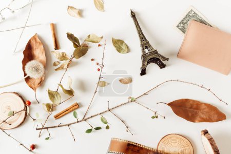 Photo for Dry autumn leaves, vintage camera films, wood pieces, cinnamon, berries, eiffel tower and wallet on white background. Fall, autumn concept. Mock up, flat lay. - Royalty Free Image