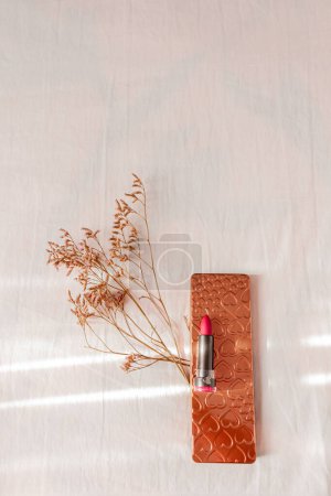 Photo for Female styled red lipstick, palette and wildflowers on wooden background. Flat lay, top view trendy feminine background. - Royalty Free Image