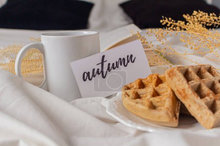 Photo for Morning breakfast with mug and waffles on the bed. Autumn food composition. - Royalty Free Image