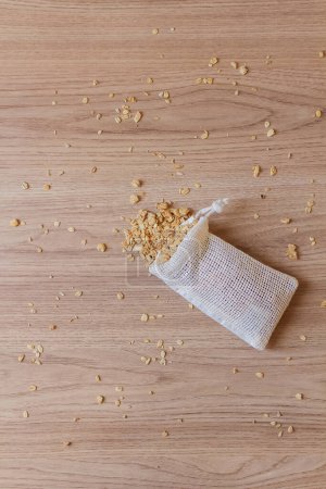 Photo for Top view of granola in cotton bag on wooden background - Royalty Free Image