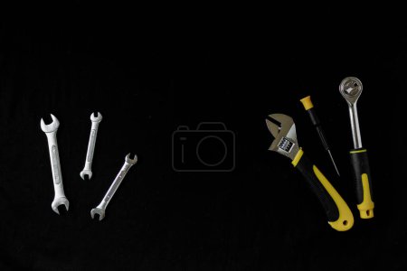 Photo for Maintenance, construction tools on black, dark background. - Royalty Free Image