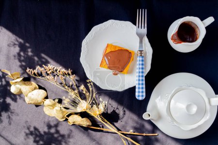 Foto de Concepto de desayuno. Sabrosa paz de pastel de zanahoria brasileña con chocolate y tetera a un lado - Imagen libre de derechos
