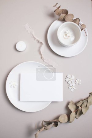 Photo for Wedding invitation card and fresh flowers on kitchenware on gray background. Flat lay, top view. - Royalty Free Image