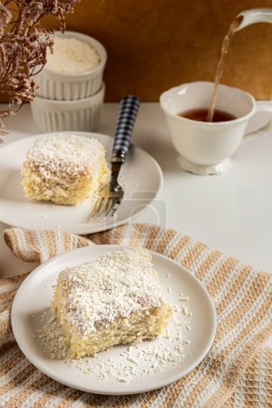 Photo for Breakfast composition with coconut cake and cup of tea - Royalty Free Image